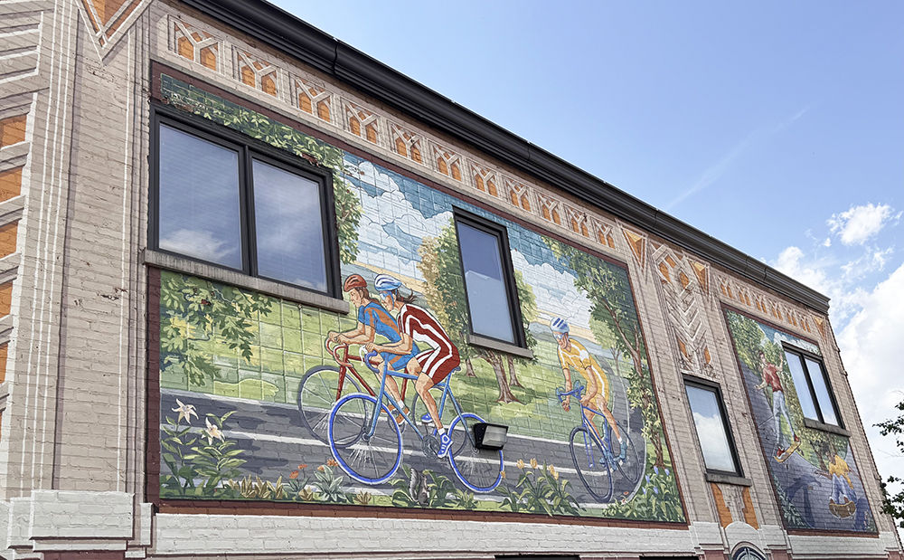 Whimsical artwork on the parking lot side of the GoodSpeed Cycling building is one of Homewood's 15 murals designed by artist Richard Haas. (Karen Torme Olson/H-F Chronicle)