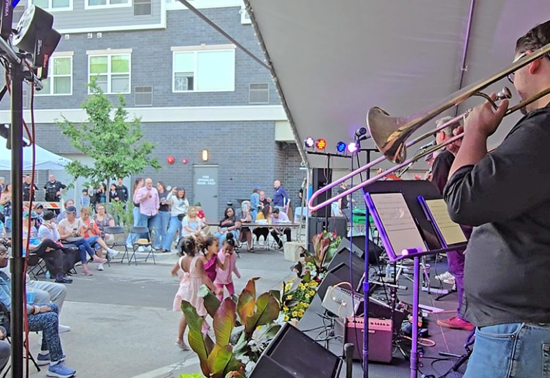 Not My Dad and the South Side Horns get three youngsters dancing at Homewood Art & Garden Fair with the band's rock covers. (Eric Crump/H-F Chronicle)