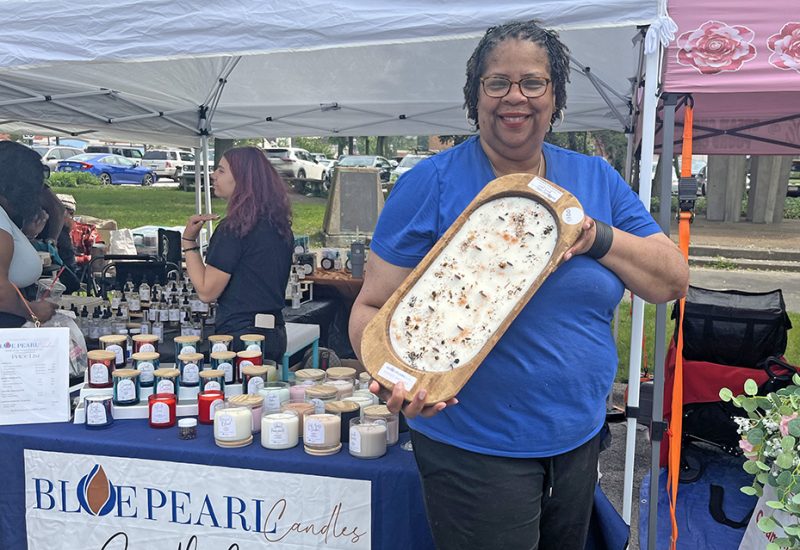 Blue Pearl Candles owner Kim Rowe debuts a 12-wick candle at Homewood Art & Garden Fair. (Nick Ulanowski/H-F Chronicle)
