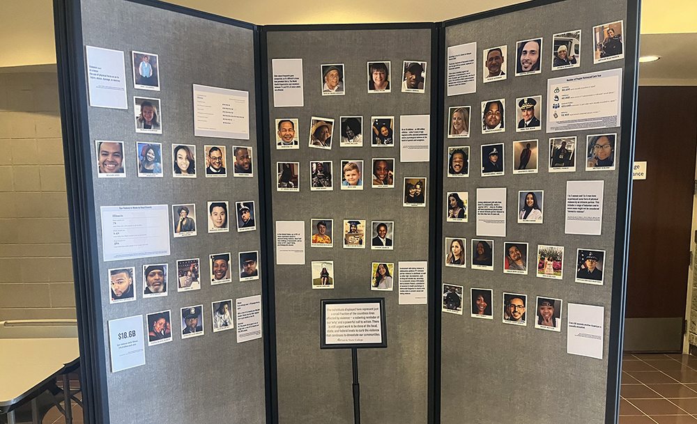 A three-panel poster with the photos and names of people who died from gun violence. (Nick Ulanowski/H-F Chronicle)