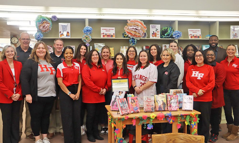 Lauren Freeman, front row in black, is surrounded by reading specialists and teachers who have helped convert the reading program at Homewood-Flossmoor High. The International Literacy Association presented H-F with the Exemplary Reading Program Award. (Provided photo)