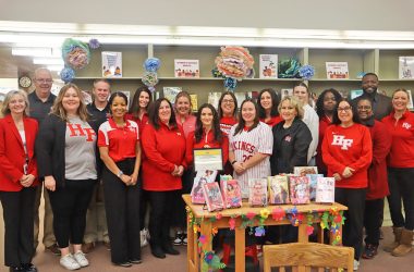 Lauren Freeman, front row in black, is surrounded by reading specialists and teachers who have helped convert the reading program at Homewood-Flossmoor High. The International Literacy Association presented H-F with the Exemplary Reading Program Award. (Provided photo)