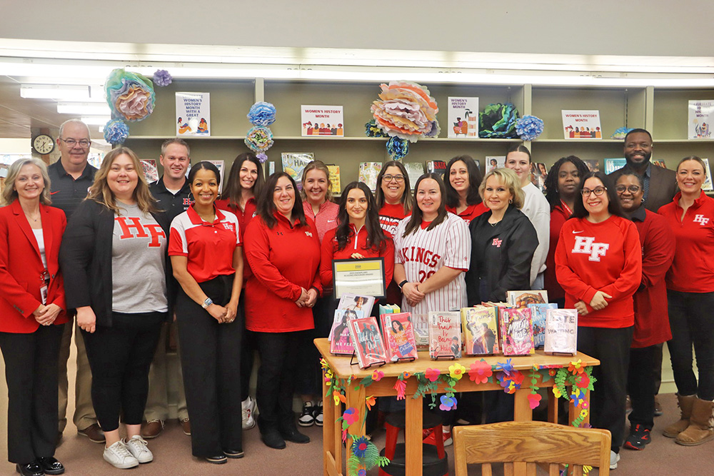 Lauren Freeman, front row in black, is surrounded by reading specialists and teachers who have helped convert the reading program at Homewood-Flossmoor High. The International Literacy Association presented H-F with the Exemplary Reading Program Award. (Provided photo)