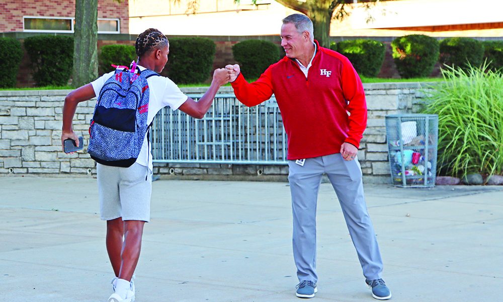 Superintendent Scott Wakeley gets a fist-bump from a student at the start of his day. (Provided photo)