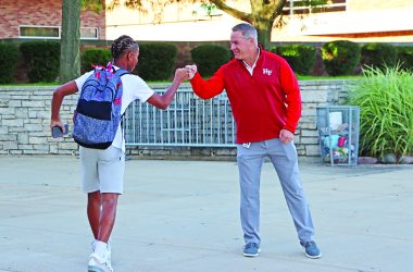 Superintendent Scott Wakeley gets a fist-bump from a student at the start of his day. (Provided photo)