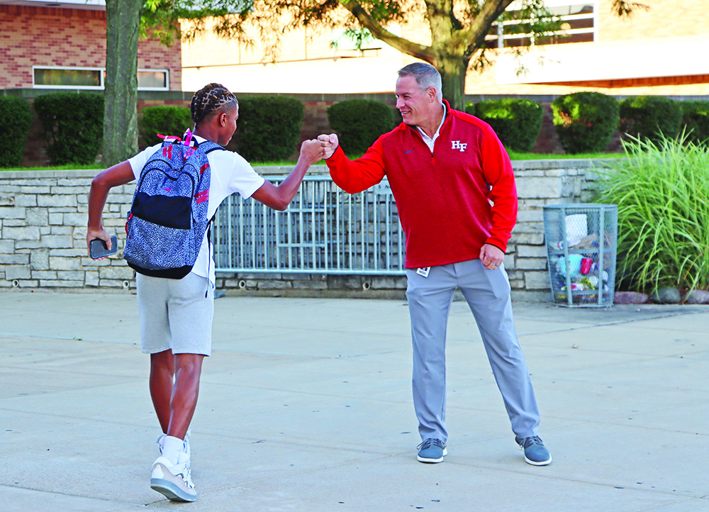 Superintendent Scott Wakeley gets a fist-bump from a student at the start of his day. (Provided photo)