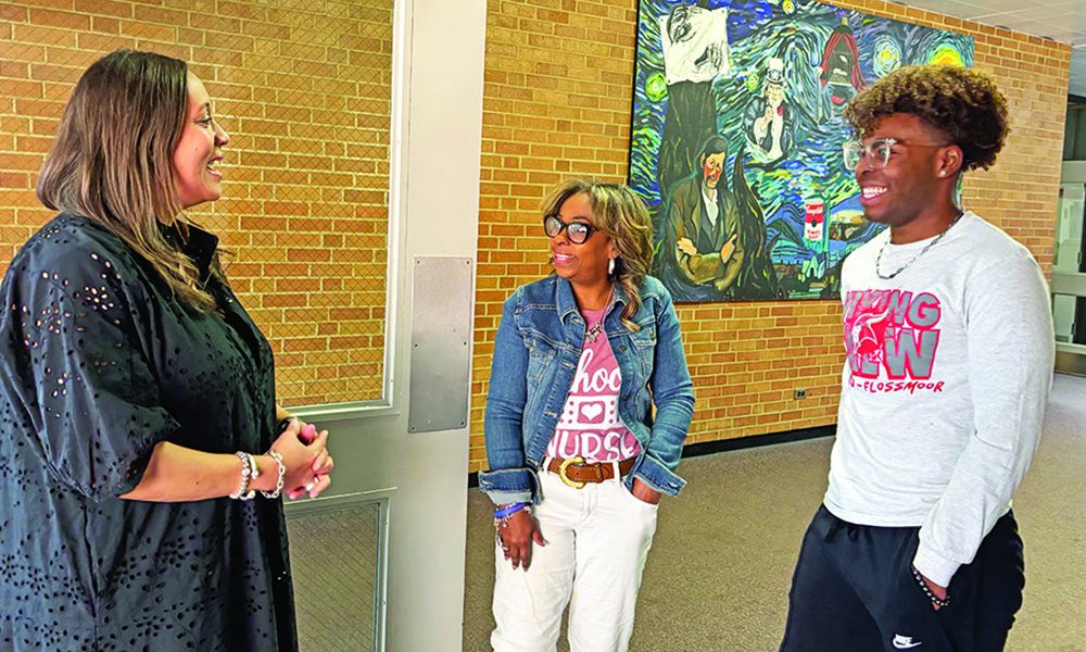 Incoming District 233 Superintendent Jennifer Norrell, left, greets Valerie Leak and her son Quentin Leak. (Marilyn Thomas/H-F Chronicle)