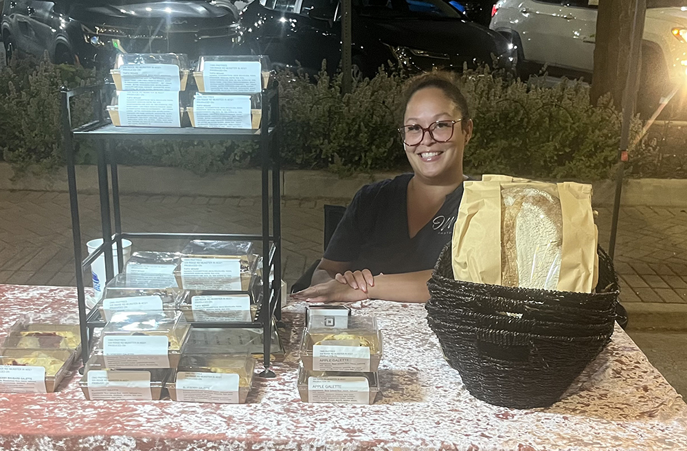 Nikki Harden operates the OMG Pastries booth at the first Homewood block party of the summer. (Nick Ulanowski / H-F Chronicle)