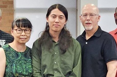 Homewood-Flossmoor High senior Julian Grisius, center, with his parents Kim Kong, left, and James Grisius, earned a perfect score on the ACT assessment test. (Marilyn Thomas/H-F Chronicle)