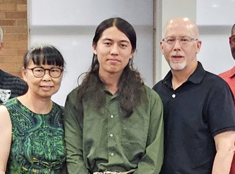 Homewood-Flossmoor High senior Julian Grisius, center, with his parents Kim Kong, left, and James Grisius, earned a perfect score on the ACT assessment test. (Marilyn Thomas/H-F Chronicle)