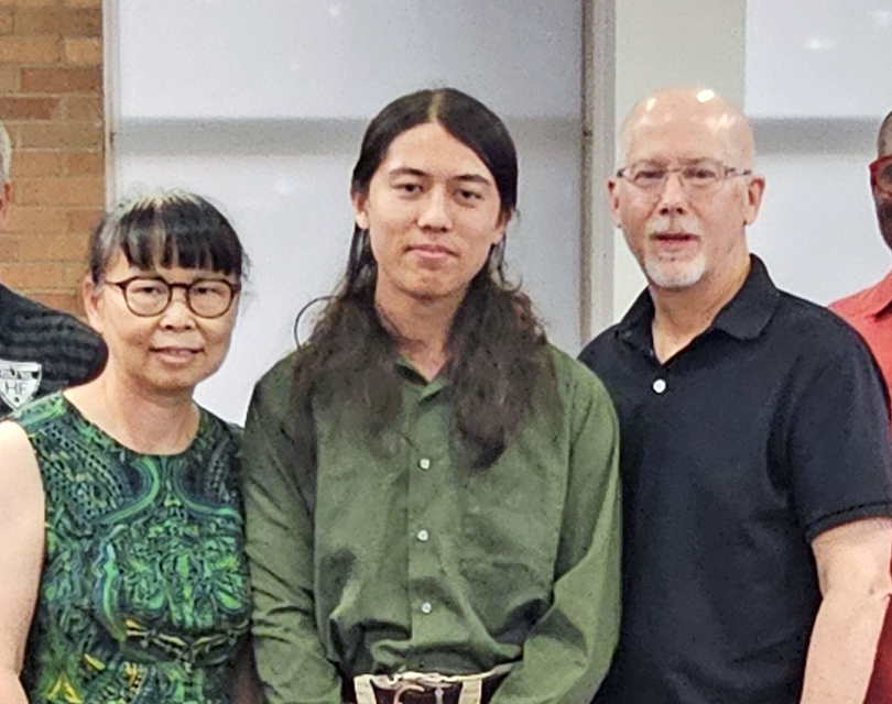 Homewood-Flossmoor High senior Julian Grisius, center, with his parents Kim Kong, left, and James Grisius, earned a perfect score on the ACT assessment test. (Marilyn Thomas/H-F Chronicle)