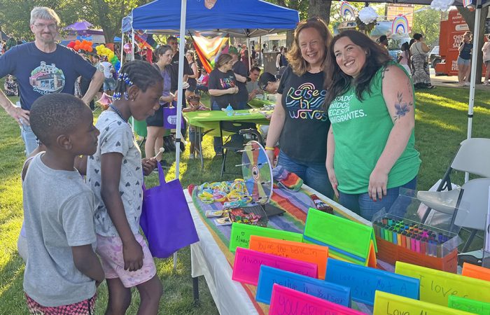 Homewood youngsters, Kason Herman and Amara Herman, spin the wheel to receive prize stickers at the Star Services booth. Rich Wojcikowski, left, and Sertoma Star Services volunteers Jen Wojcikowski, center, and Veronica Cullinan, right, pose for the photo. (Nick Ulanowski/H-F Chronicle)