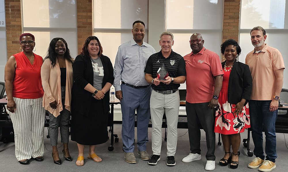 Retiring District 233 Superintendent Scott Wakeley, fourth from right, poses with board members, from left, Pam Jackson, Tamekia Smith, Ariana Leonard, Nathan Legardy, Wakeley, Gerald Pauling, Camille O'Quin and Chris Riedel. (Provided photo)