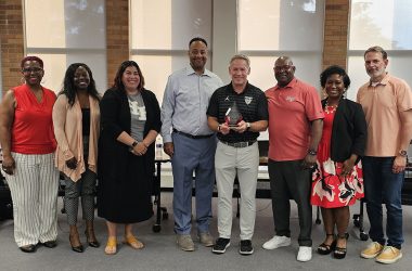 Retiring District 233 Superintendent Scott Wakeley, fourth from right, poses with board members, from left, Pam Jackson, Tamekia Smith, Ariana Leonard, Nathan Legardy, Wakeley, Gerald Pauling, Camille O'Quin and Chris Riedel. (Provided photo)