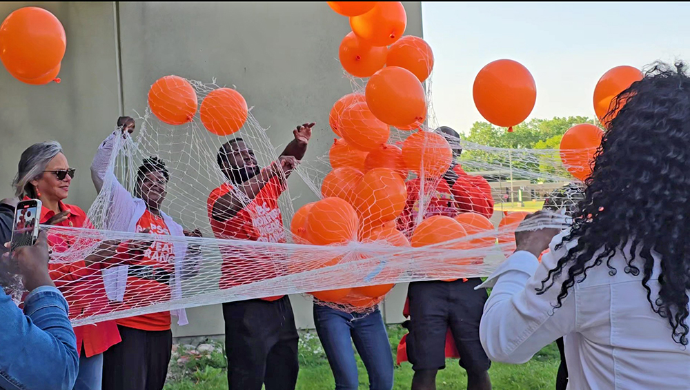 Congresswoman Robin Kelly, left, helps release biodegradable balloons at Prairie State College on May 31 to honor the lives of those lost to gun violence. (Eric Crump/H-F Chronicle)