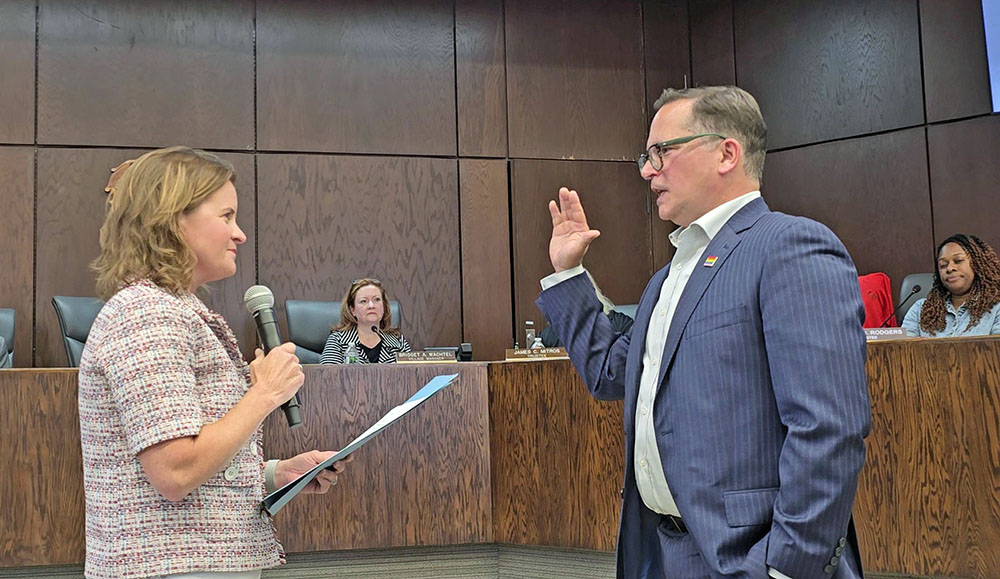 Flossmoor Mayor Michelle Nelson administers the oath of office to Village Clerk Cecil Porter. He will serve the balance of the term left vacant by former clerk Gina LoGalbo's resignation. (Eric Crump photos/H-F Chronicle)