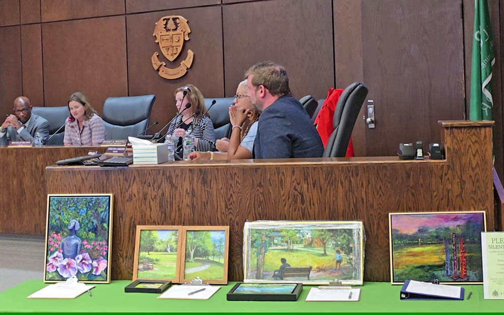 Plein air paintings on display at the Flossmoor board meeting Monday, July 21, can be bid on in a silent auction in conjunction with Chamber Night on Thursday, July 24. Proceeds of the auction will benefit the Flossmoor Public Art Commission. (Eric Crump/H-F Chronicle)