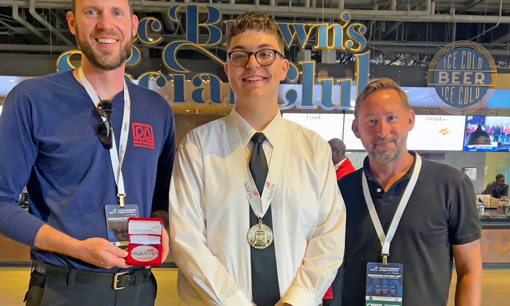 Homewood-Flossmoor High School senior Charley Dieringer, center, was congratulated by teachers Bill Merchantz, left, and Greg Petecki, right, who accompanied him to the Skills USA competition in Atlanta where Dieringer won national honors. (Provided photo)