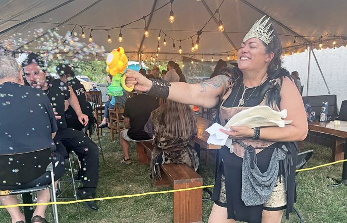 Rabid Brewing co-owner Raiye Rosado blows bubbles into the crowd with a bubble-making device during the Feast of the Goat Queen in 2025. (Nick Ulanowski / H-F Chronicle)