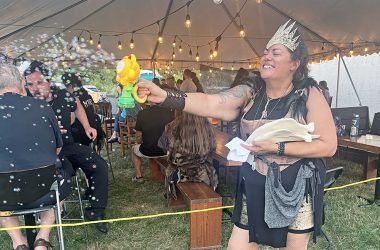 Rabid Brewing co-owner Raiye Rosado blows bubbles into the crowd with a bubble-making device during the Feast of the Goat Queen on July 26. (Nick Ulanowski / H-F Chronicle)