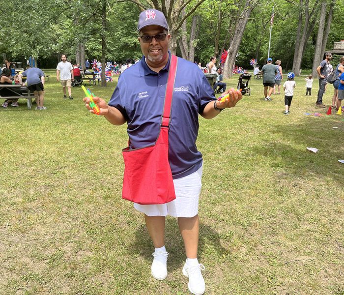 Homewood Village Trustee Phillip Mason walks around the Izaak Walton 4th of July picnic and handing out bubble makers to community members. (Nick Ulanowski / H-F Chronicle)