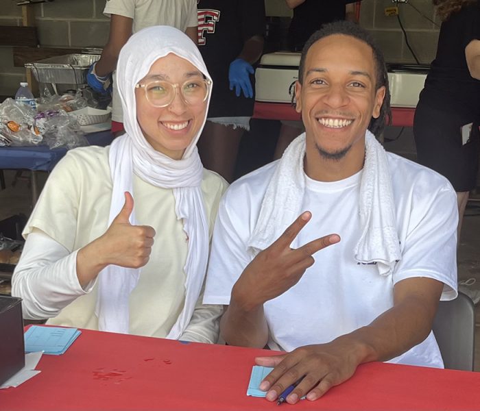Izaak Walton museum committee member Kirsten Mustafa, left, and Cameron Mustafa serve food at the annual 4th of July community picnic. (Nick Ulanowski / H-F Chronicle)