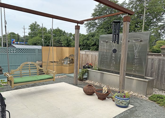 Garden Walk Diane fountain_web A waterfall created by sculptor Jason Verbeek helps create a quiet oasis for homeowner Diane DuBois. (Marilyn Thomas/H-F Chronicle)