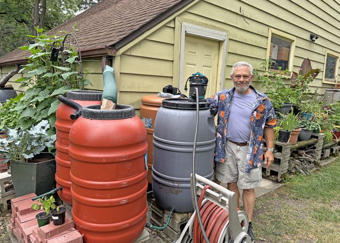 Garden Walk Larry Burrows_web Larry Burrows has more than 20 rain barrels. He uses a submersible pump to get water throughout his garden. (Marilyn Thomas/H-F Chronicle)
