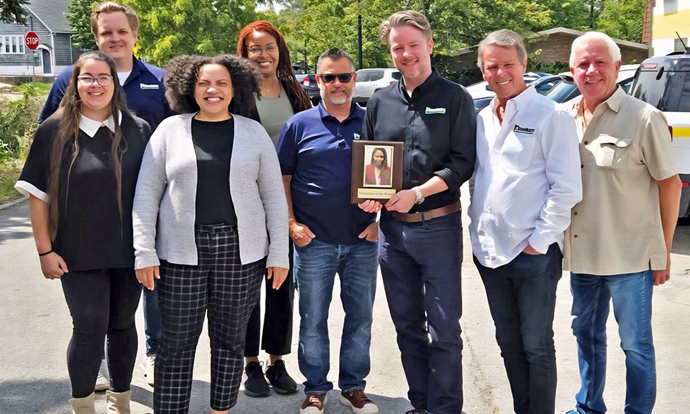 Jarriesa Roberts, fourth from left, receives an Employee Of the Month from Hoekstra HVAK. Spencer Hoekstra co-owner Spencer Hoekstra holding up the plaque. Amber Crews, far left, John Hall, Jen Cottrell, Steve Binner, Douglas Hoekstra and Lee Hoekstra, far right, pose for the camera. (Provided photo)