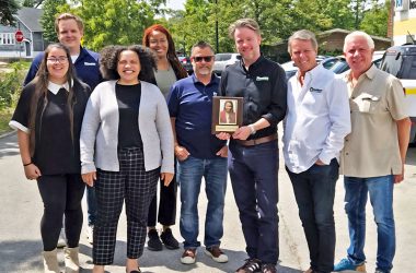 Jarriesa Roberts, fourth from left, receives an Employee Of the Month from Hoekstra HVAK. Spencer Hoekstra co-owner Spencer Hoekstra holding up the plaque. Amber Crews, far left, John Hall, Jen Cottrell, Steve Binner, Douglas Hoekstra and Lee Hoekstra, far right, pose for the camera. (Provided photo)