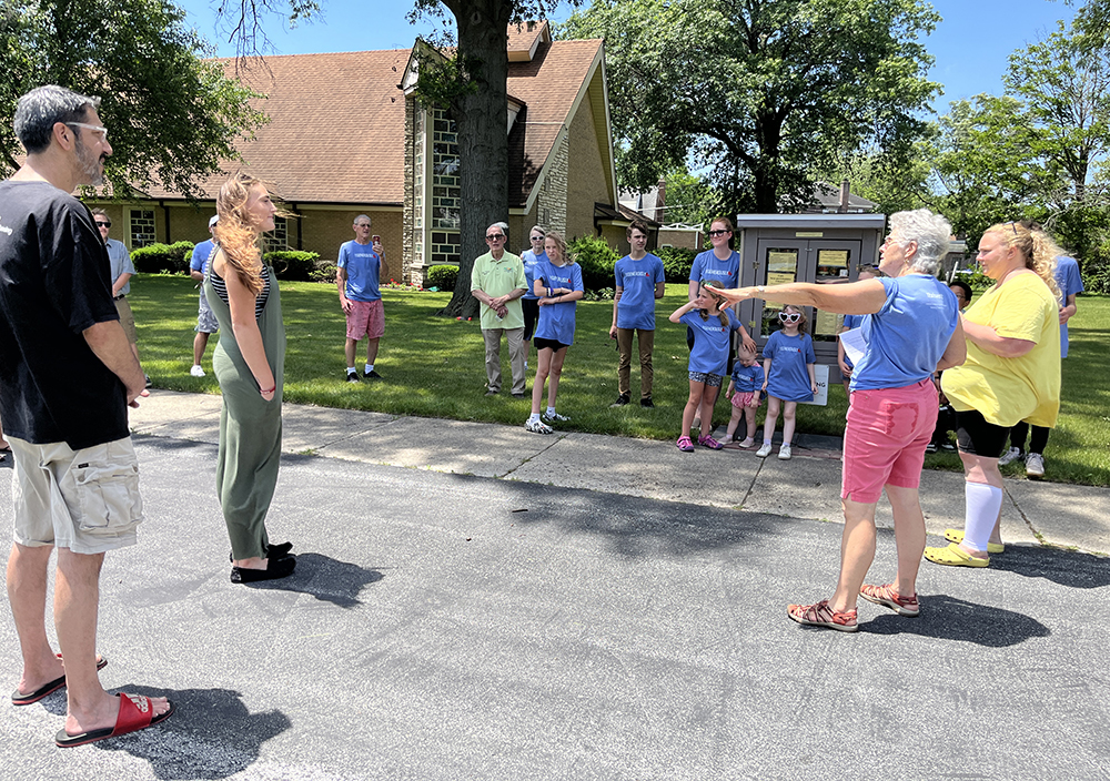 Lorie Zoellick, Salem Lutheran’s Community Outreach coordinator, second from right, thanks the crowd and the youth builders during the micro-pantry dedication. (Nuha Abdessalam/H-F Chronicle)