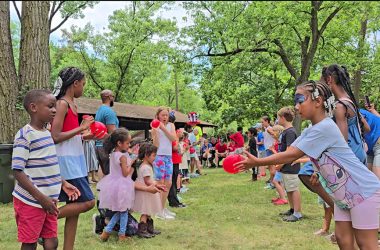 Jamin Hampton, left, and Myracle Dunning are partners in one of the balloon toss games during the Izaak Walton community picnic on the 4th of July. (Eric Crump/H-F Chronicle)