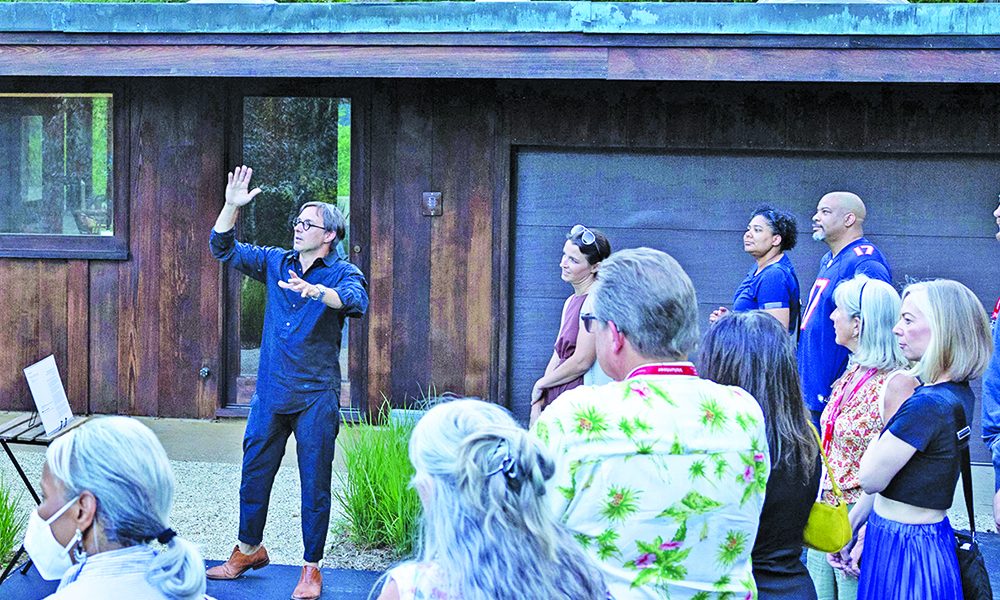 Edward Peck, center with arm raised, speaks to guests at the 2023 Modernism Road Rally. (Provided photo by Marcellus Marsh/Bionic Content)