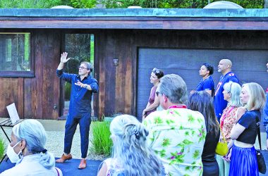 Edward Peck, center with arm raised, speaks to guests at the 2023 Modernism Road Rally. (Provided photo by Marcellus Marsh/Bionic Content)