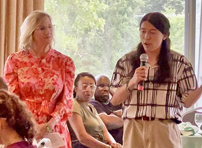 Edie Dobrez, Homewood Science Center’s executive director, left, listens as Julian Grisius, former participant of the Homewood Science Center shares memories of his experience from the center at the Summer Fest. (Summer Kiswani/ H-F Chronicle)