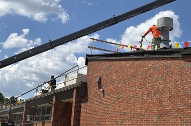 Crew members from CDF Roofing work under the hot sun tarring a section of the Willow School roof in Homewood. (Marilyn Thomas/H-F Chronicle)