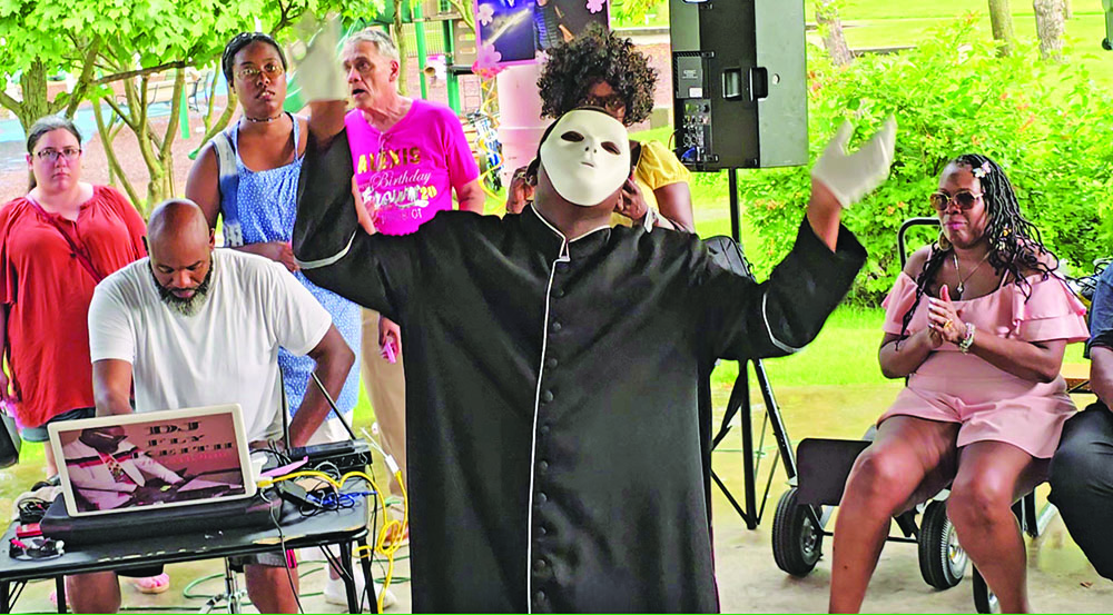 Demarcus Harris performs a mime dance during the butterfly release event in honor of the late Alexis Wilson. (Eric Crump/H-F Chronicle)