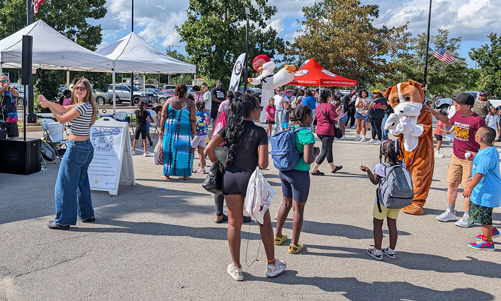 Community members enjoy the festivities at Homewood's 2025 back-to-school party. (Chris Weber/H-F Chronicle)