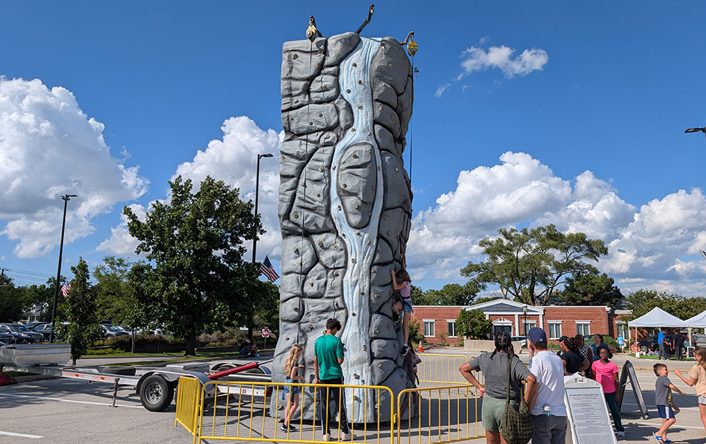 Kids climb the the rock wall at the District 153 Back to School event Saturday, Aug. 23. (Chris Weber/H-F Chronicle)