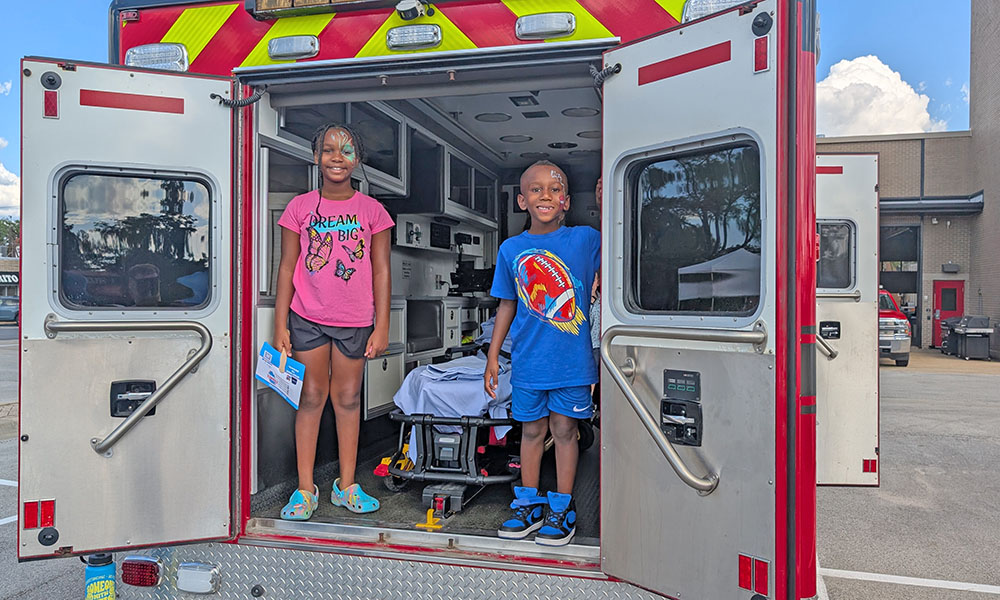 Norah and Eric Bryant enjoy a look inside the ambulance at the Homewood Back to School event on Aug. 23. (Chris Weber/H-F Chronicle)