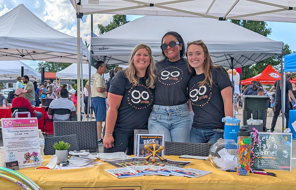 From left, Aubrey Kuiper, Morgan Rigsby and Lauren Veste from Grant Orthodontics welcomed students back with games and fun activities. (Chris Weber/H-F Chronicle)
