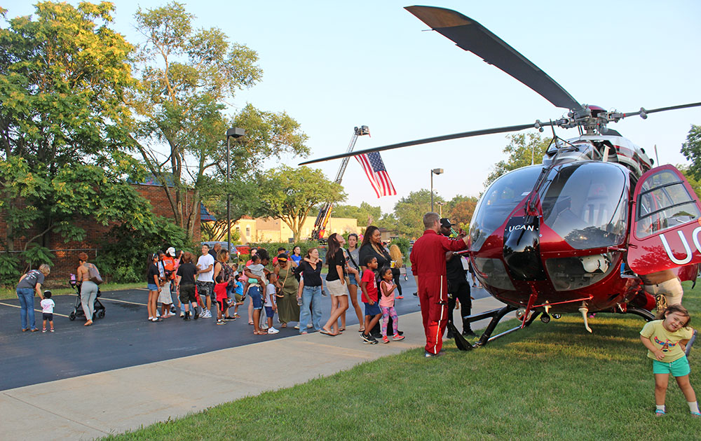 A line forms as kids and adults waited their turn to sit inside the UCAN helicopter during National Night Out in Flossmoor. (Nuha Abdessalam/H-F Chronicle)