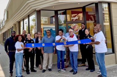 Annah Mitchell, center, owner of Gobble Doggs, cuts the ribbon with Homewood Mayor Rich Hofeld to officially open the hot dog restaurant on Ridge Road. (Summer Kiswani/ H-F Chronicle)