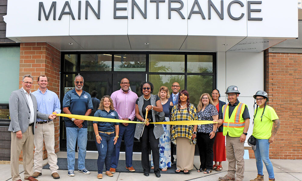 District 161 board member Ashly Giddens prepares to cut the ribbon marking the completion of Heather Hill School renovations. (Provided photo)