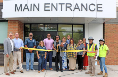 District 161 board member Ashly Giddens prepares to cut the ribbon marking the completion of Heather Hill School renovations. (Provided photo)