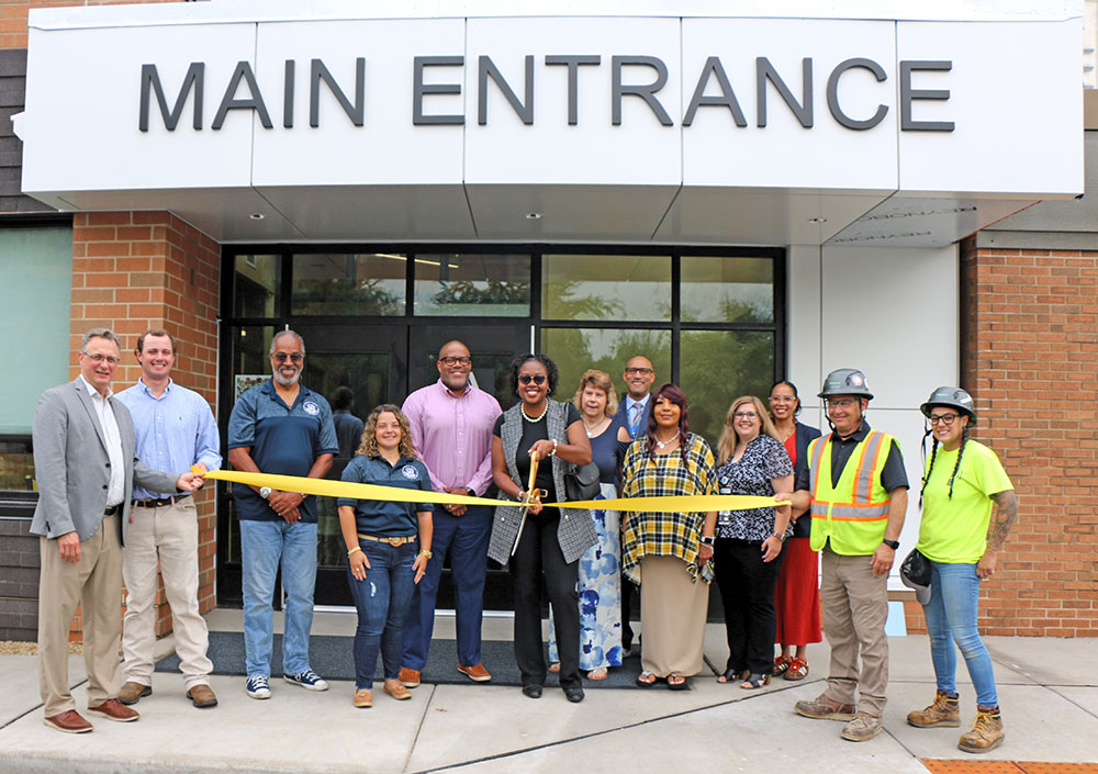 District 161 board member Ashly Giddens prepares to cut the ribbon marking the completion of Heather Hill School renovations. (Provided photo)