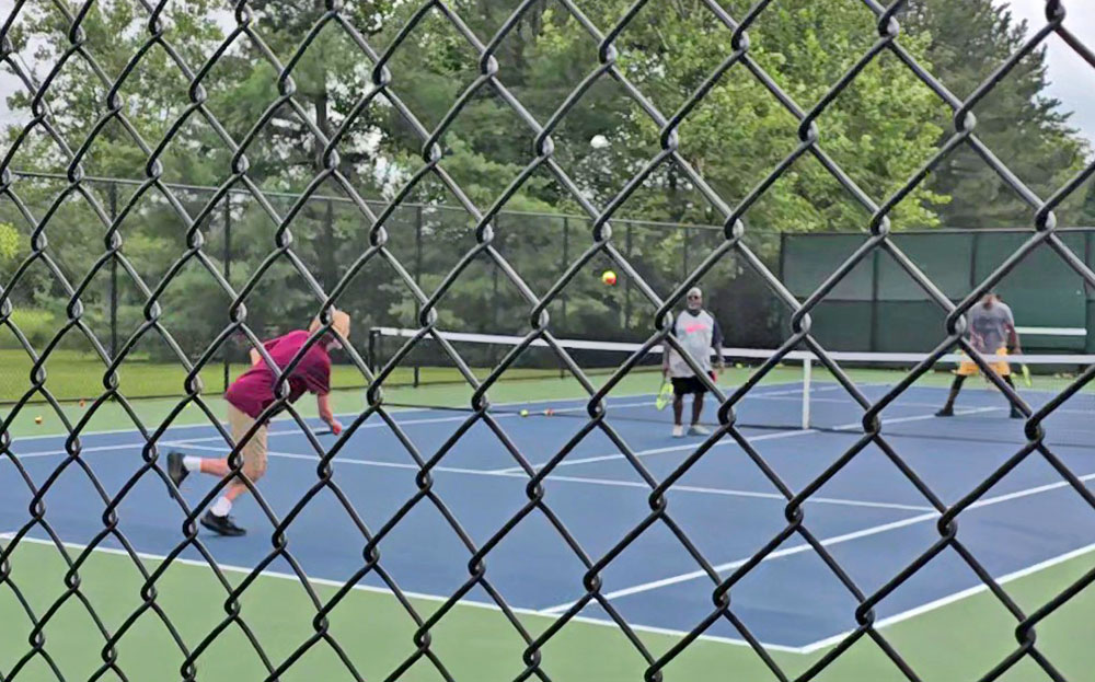 Players give the new tennis courts a try during the grand opening of Highlands Park Courts on Lawrence Crescent in Flossmoor. (Eric Crump/H-F Chronicle)