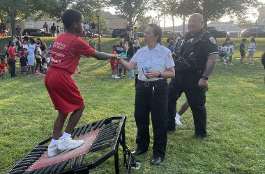 Homewood Police Chief Denise McGrath shakes hands with a Jessie White Tumbler performer at National Night Out. (Nick Ulanowski / H-F Chronicle)