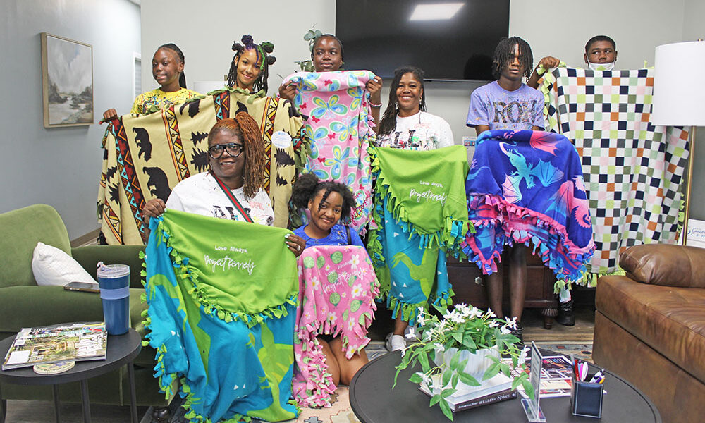 From left, Shaniya Charles, Jemiah Sykes, Amanda Thornton, Dakota Johnson, Chondra Wright, Javae Harris, Tyree Daniels, and Cinnamon Allison-Moore at the Project Kennedy Blanket Drive. (Nuha Abdessalam/H-F Chronicle)
