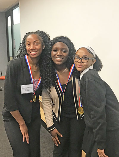 TrioSync members, from lef, Jenesys Harris, Gabriella Olugbemi and Lorin Metoyer take a celebratory photo after winning the Pitch Day competition. (Lolita Cusic/H-F Chronicle)